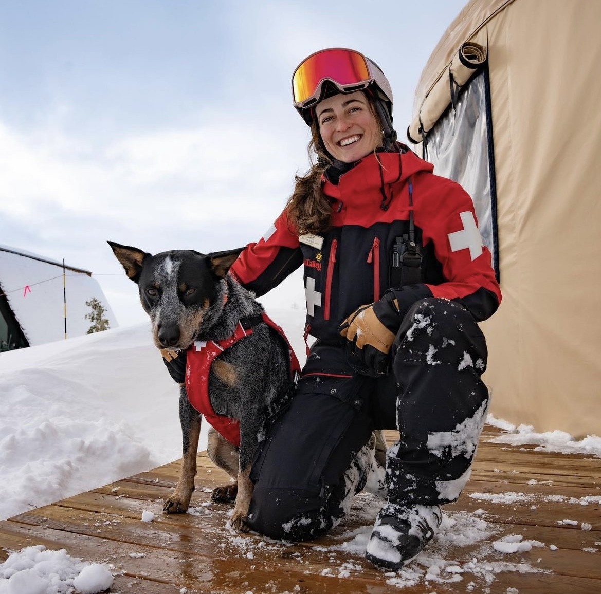 Nicole and avalanche dog, Diesel, pose on the deck of the Patrol tent.